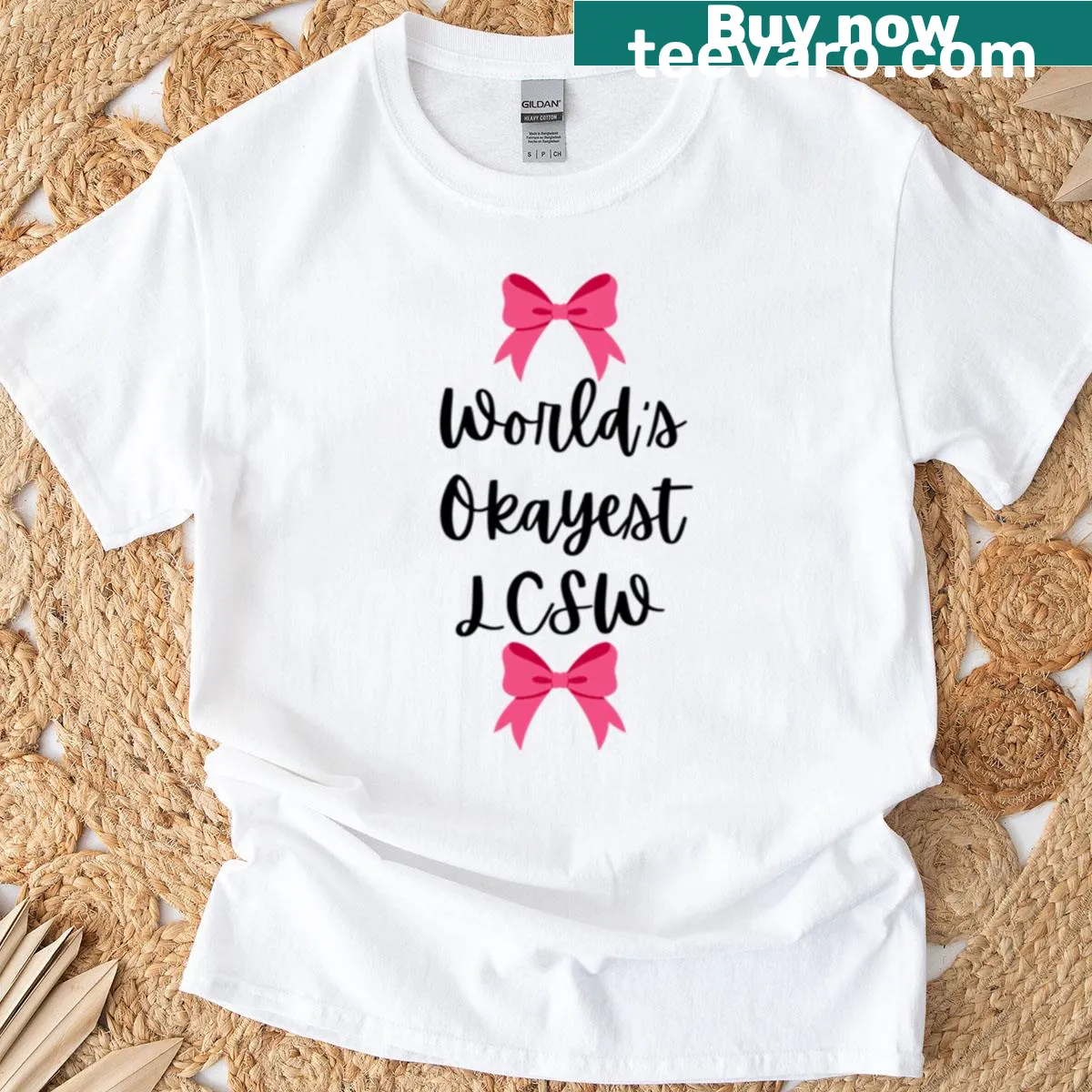 Playful World's Okayest LCSW t-shirt with pink bow design — on a men's t-shirt