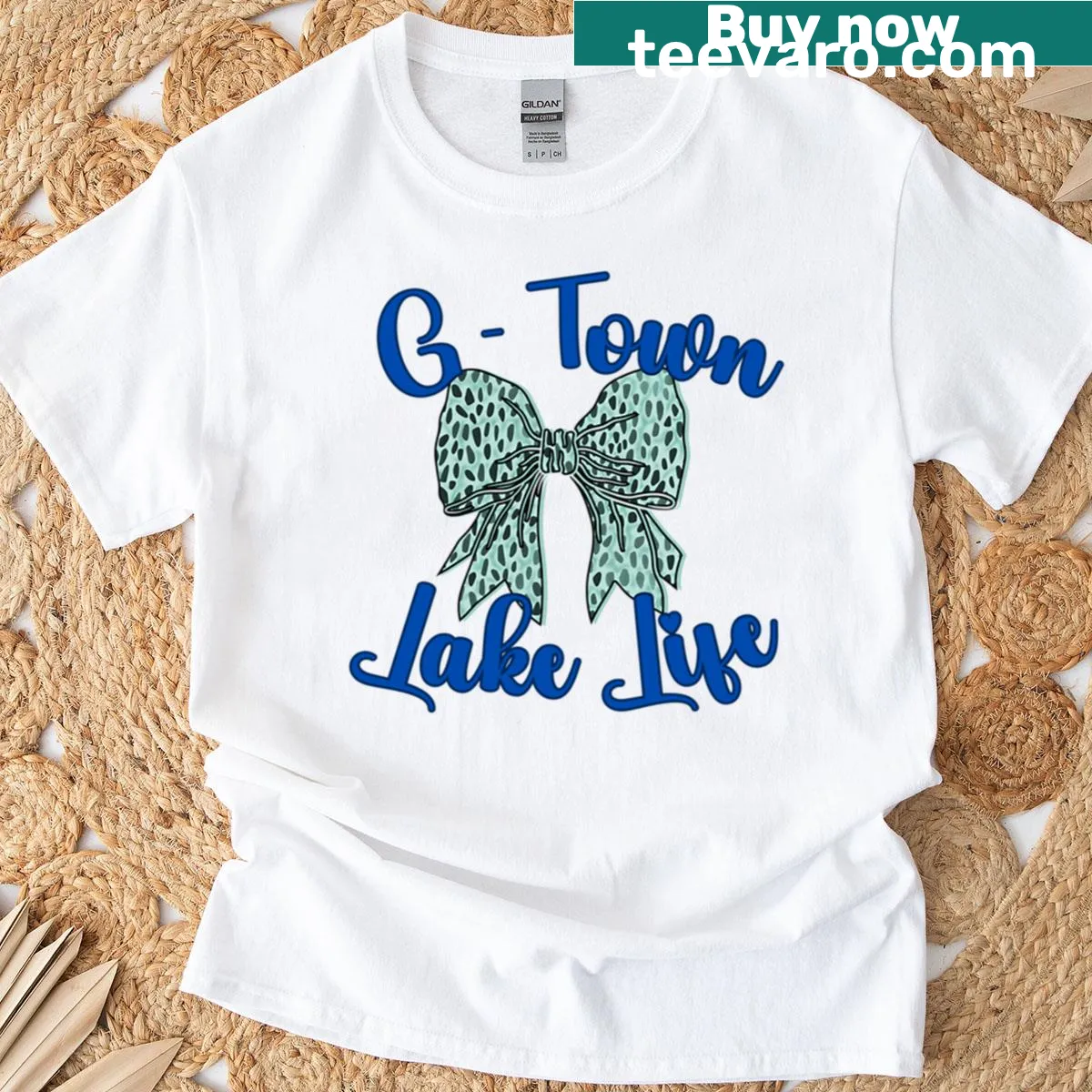 Illustrated lake life T-shirt with a bow design and playful graphics — on a men's t-shirt