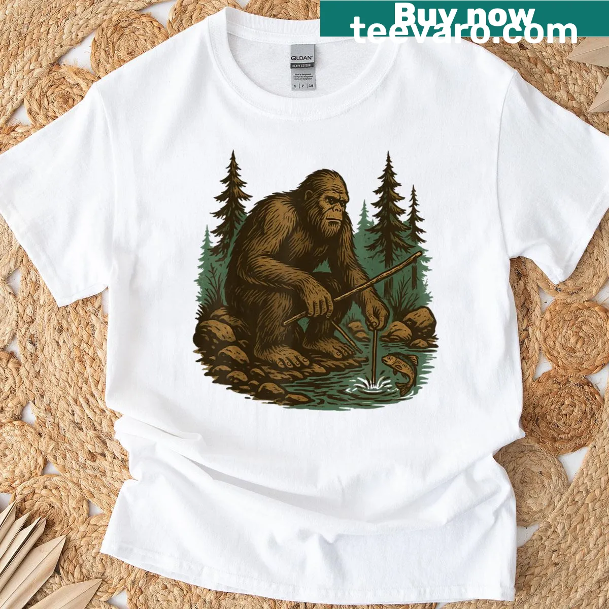T-shirt featuring Bigfoot fishing by a river in a nature scene — on a men's t-shirt