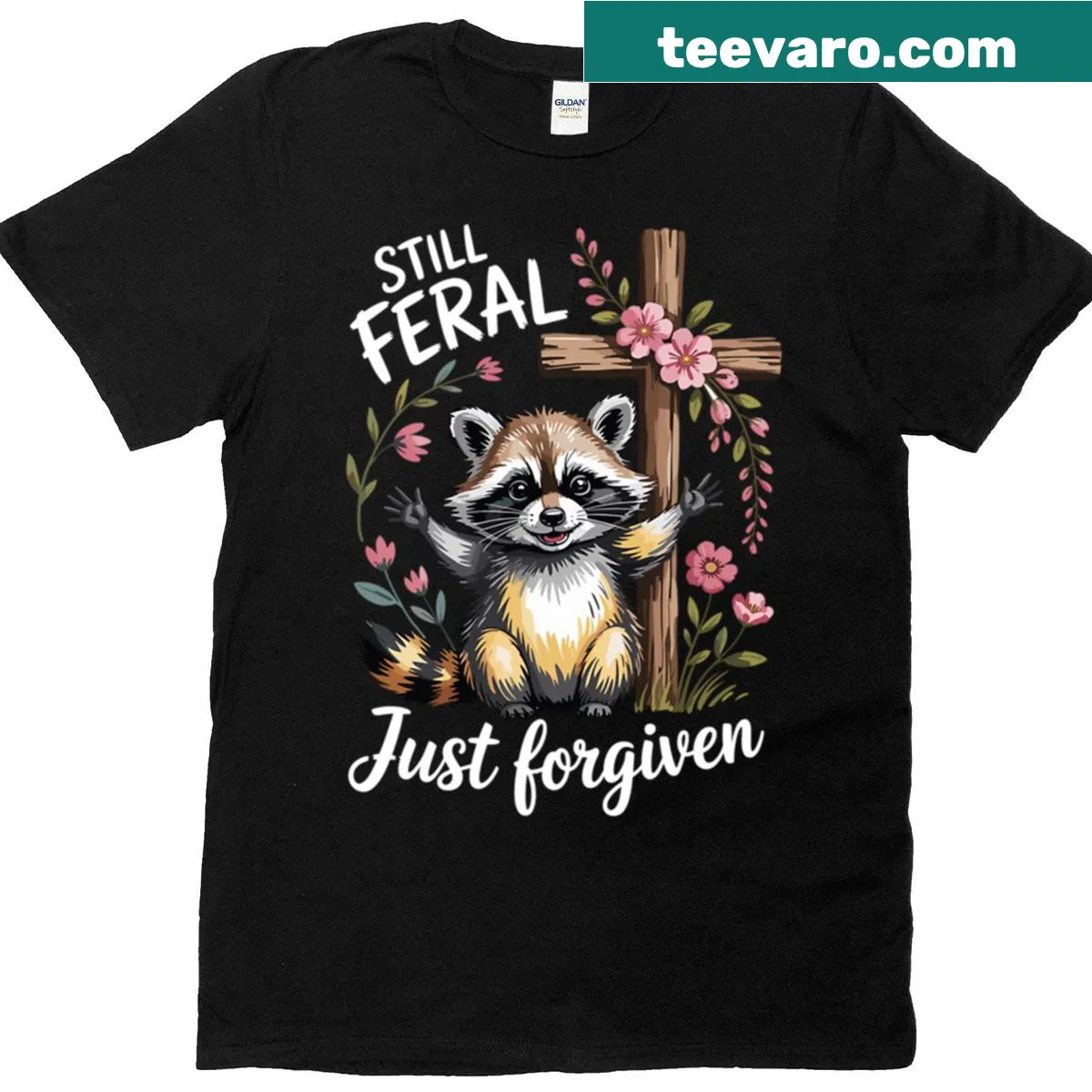 Funny Christian raccoon t-shirt with 'Still Feral Just Forgiven' text — on a men's t-shirt