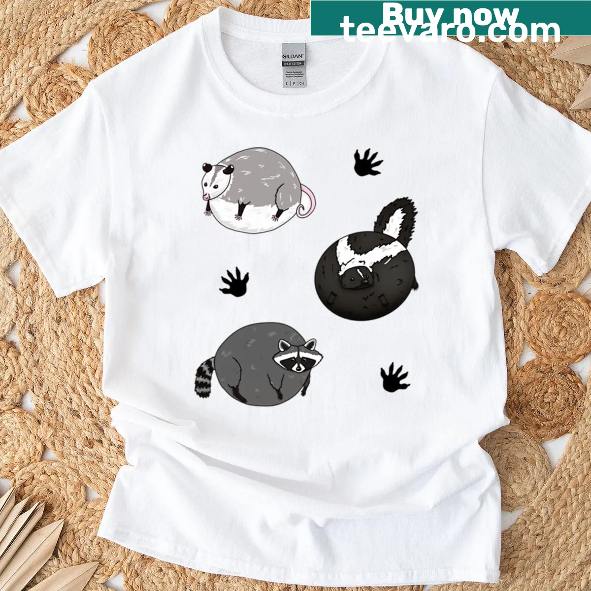 Cartoon graphic featuring raccoons, opossums, and skunks in playful poses. — on a men's t-shirt