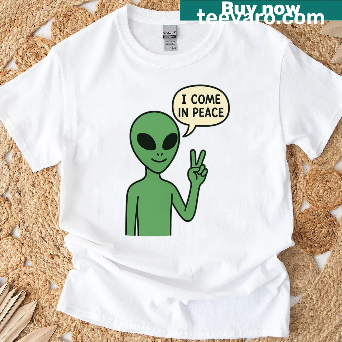 Cartoon alien with peace sign graphic on a T-shirt — on a men's t-shirt