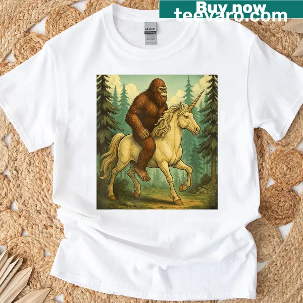 Fun T-shirt featuring Bigfoot riding a unicorn graphic.