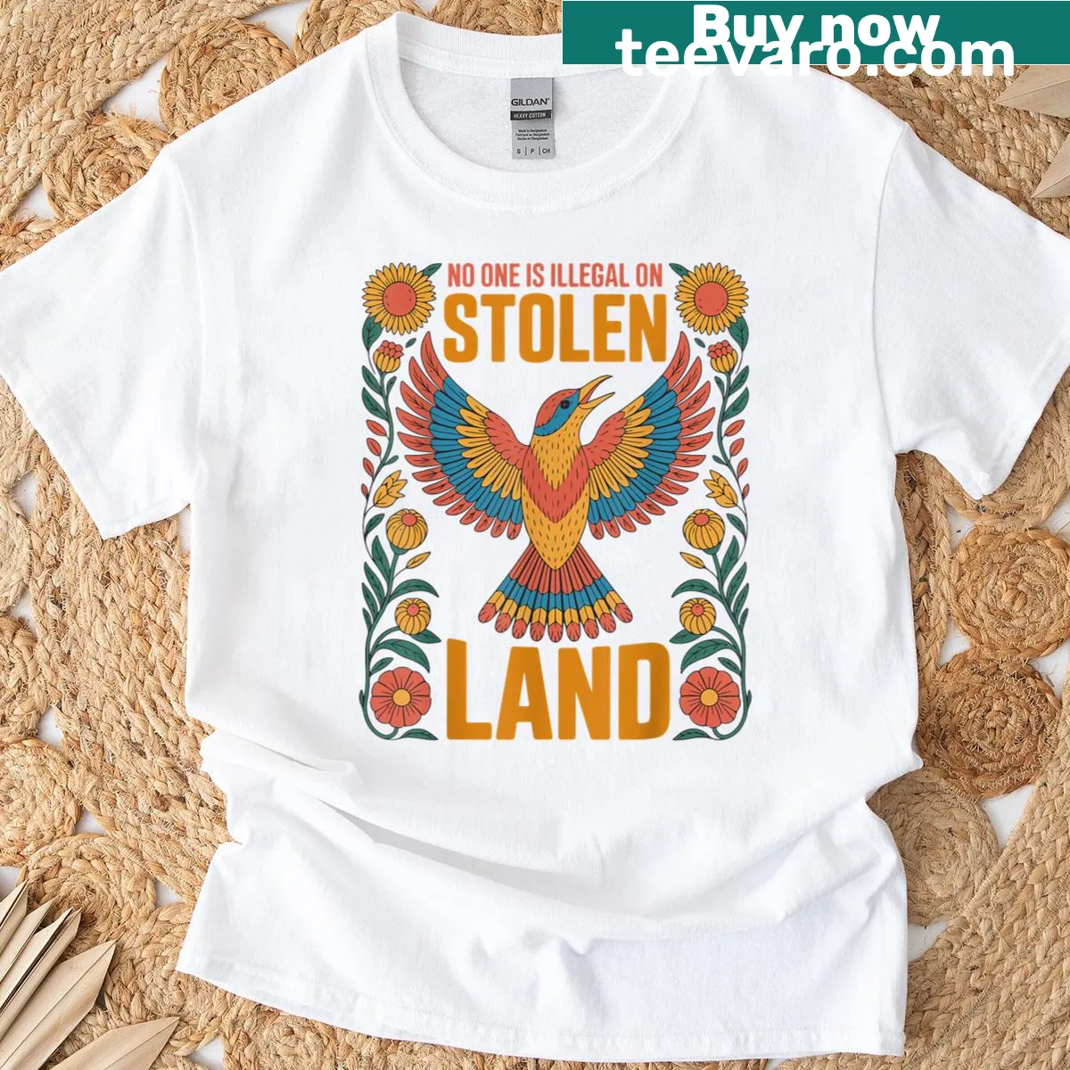 Statement t-shirt with No One Is Illegal On Stolen Land text — on a men's t-shirt