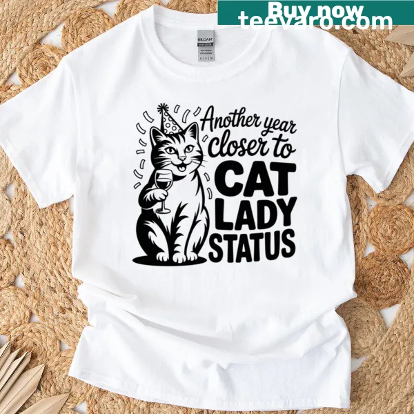 Cute T-shirt with humorous 'Cat Lady Status' design celebrating cats.
