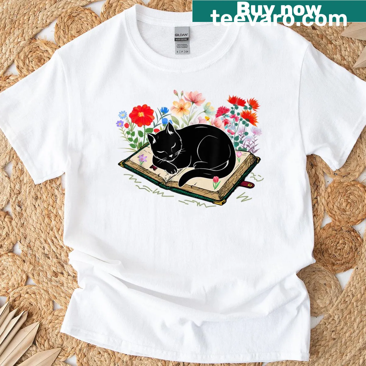 Cute black cat sleeping on a book surrounded by flowers — on a men's t-shirt