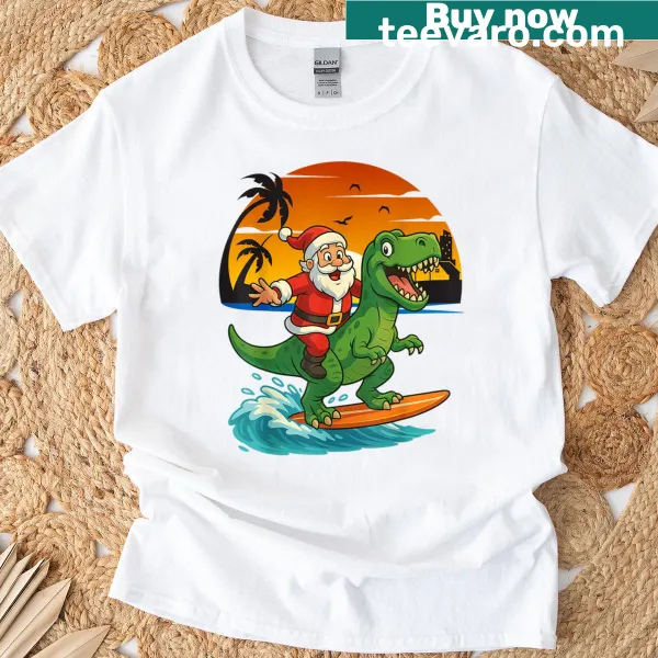 Kids T-shirt with a cartoon dinosaur surfing with Santa