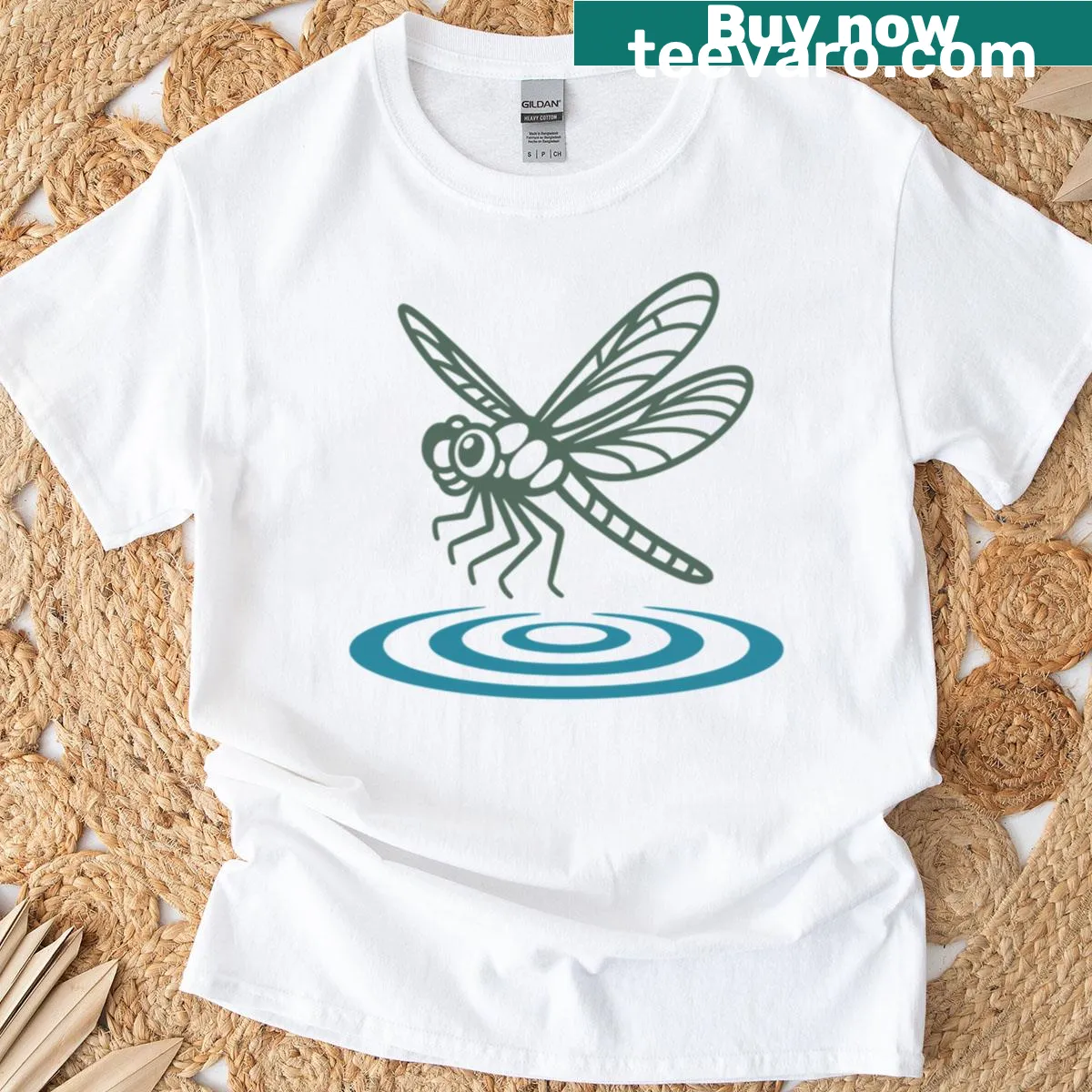 Illustrative t-shirt featuring a dragonfly over water — on a men's t-shirt