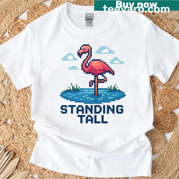 Pixel art flamingo t-shirt featuring a flamingo standing in a pond