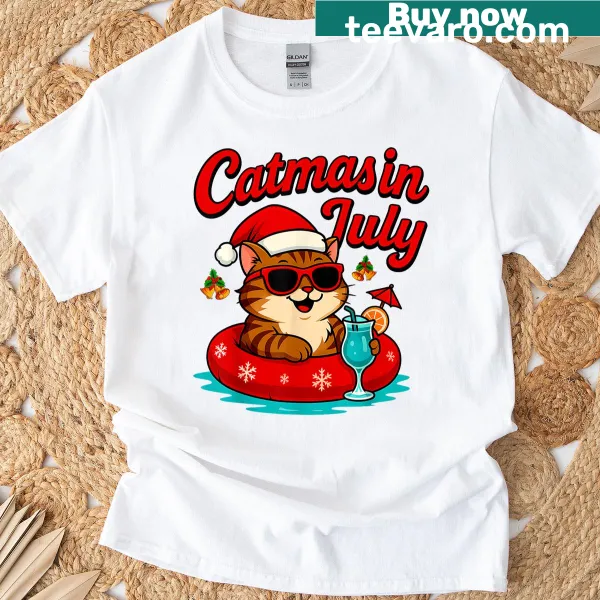 T-shirt featuring a cat in a Santa hat on a float for a summer Christmas vibe.