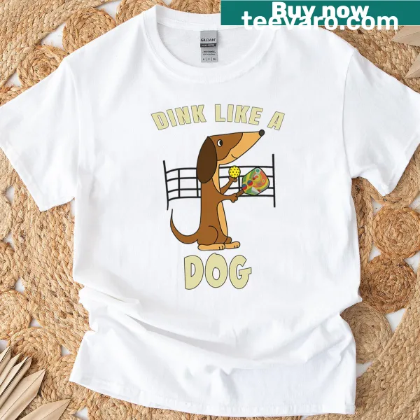 Funny cartoon T-shirt featuring a dog with a paddle playing pickleball