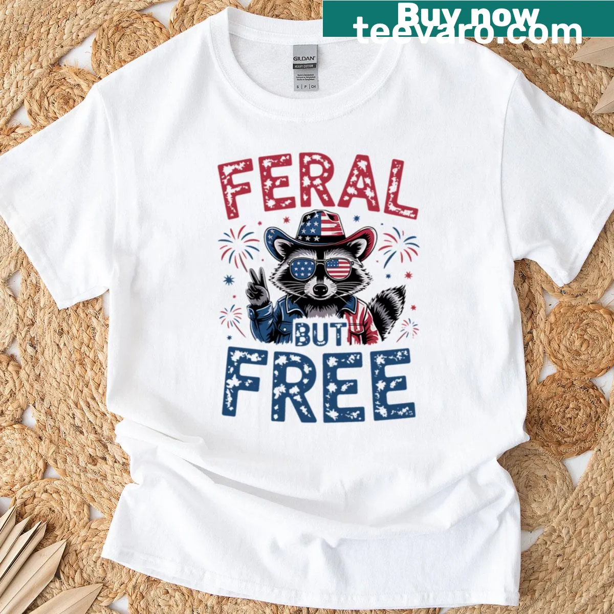 Funny 4th of July T-shirt featuring a raccoon and 'Feral But Free' text — on a men's t-shirt