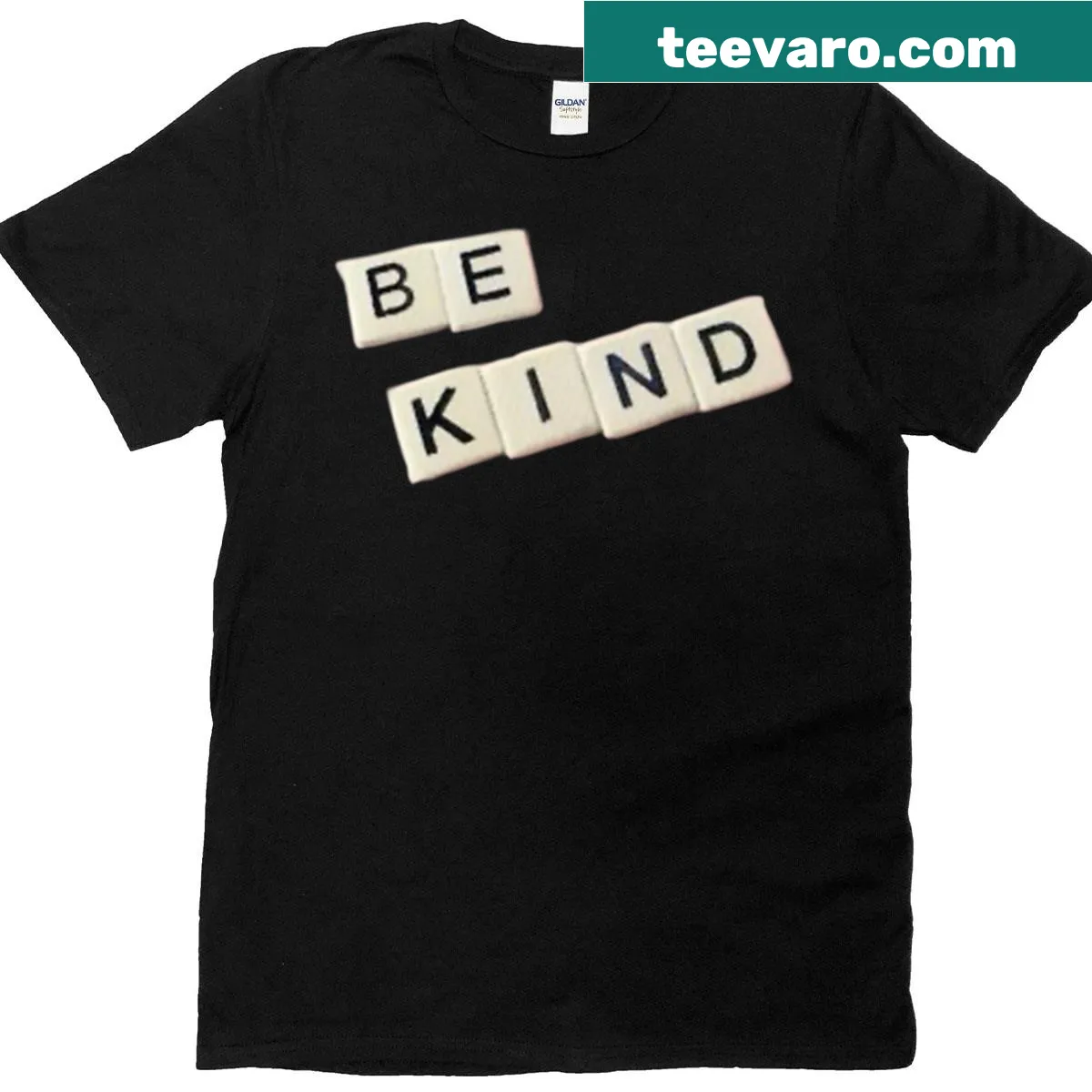Oversized t-shirt with scrabble-style text saying 'Be Kind' — on a men's t-shirt