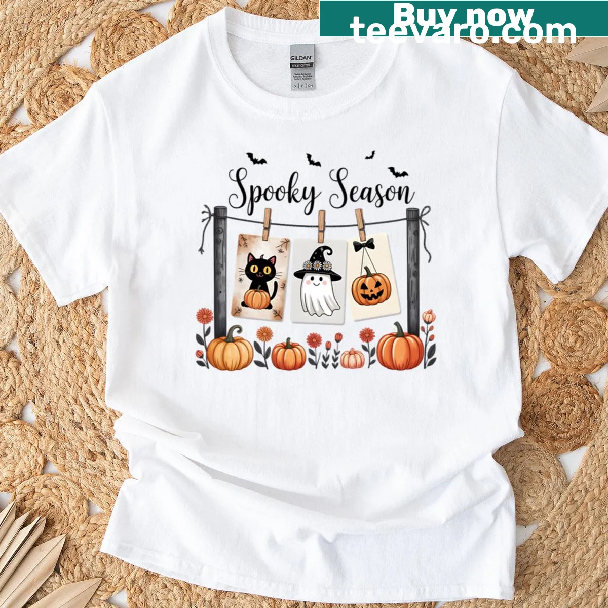 Whimsical Halloween T-shirt with black cat, ghost, and pumpkin art — on a men's t-shirt