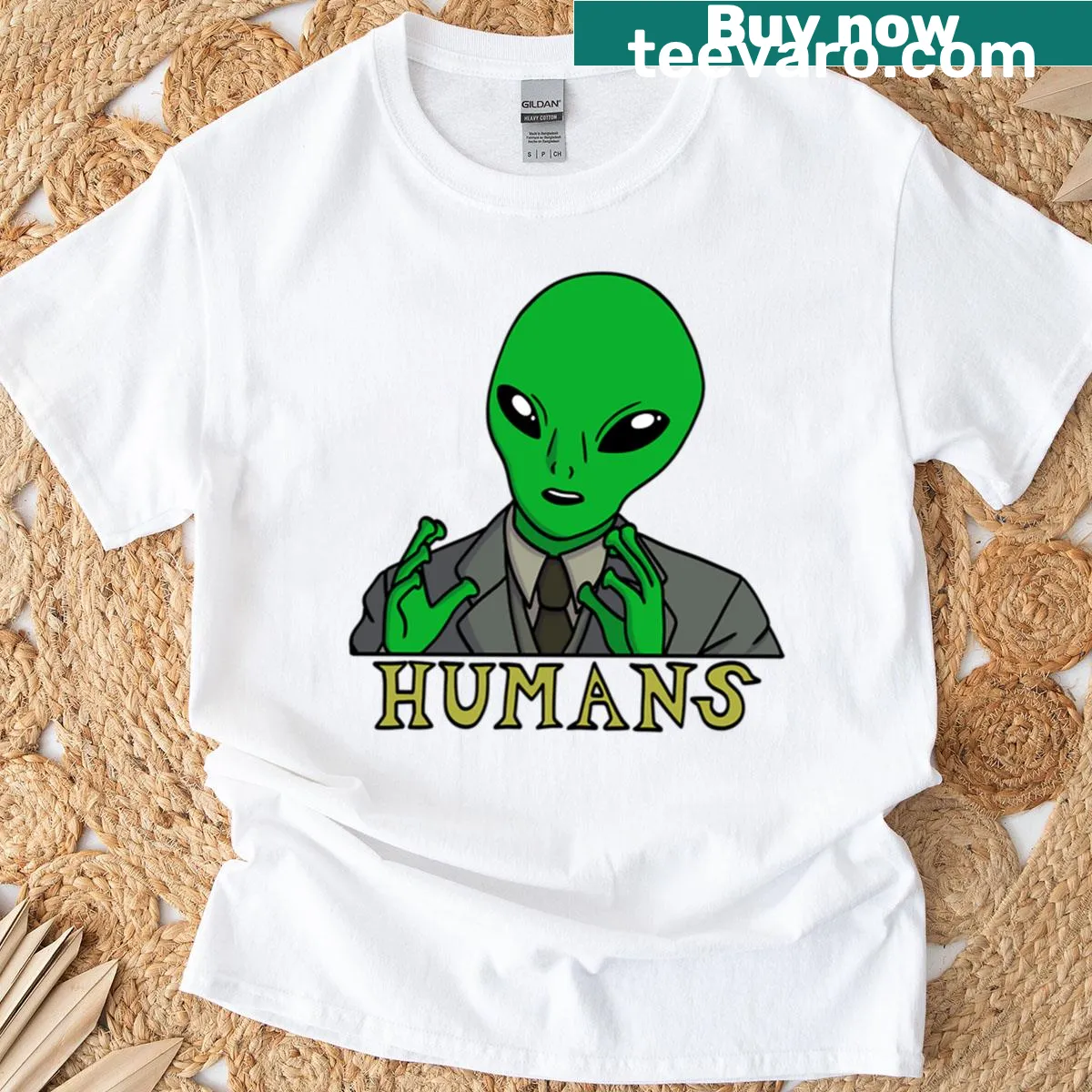 Playful t-shirt with whimsical humans and aliens graphic — on a men's t-shirt