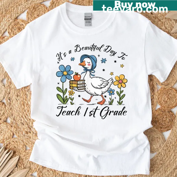 Cute cartoon goose T-shirt with text about teaching 1st grade