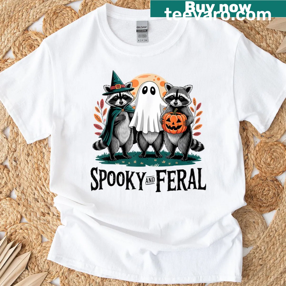 Cartoon raccoon ghost graphic on a Halloween-themed t-shirt. — on a men's t-shirt