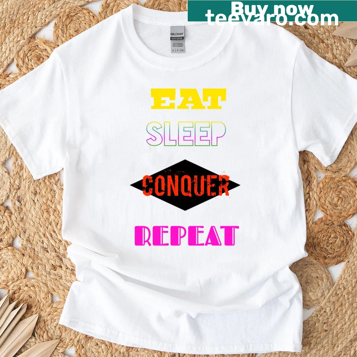 Motivational oversized t-shirt with Eat Sleep Conquer Repeat text — on a men's t-shirt