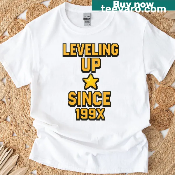 Retro gamer tee with pixel art and text 'Leveling Up Since 199x'