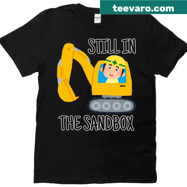 T-shirt featuring the phrase 'Still In The Sandbox' in playful typography.