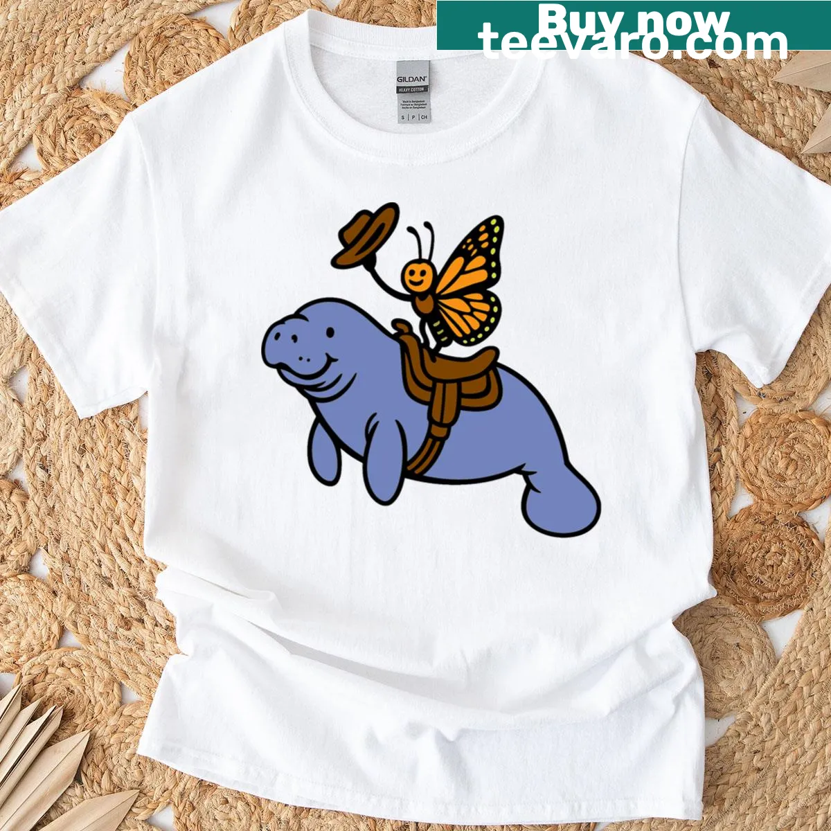 Cartoon design of a manatee with butterflies in a rodeo setting — on a men's t-shirt