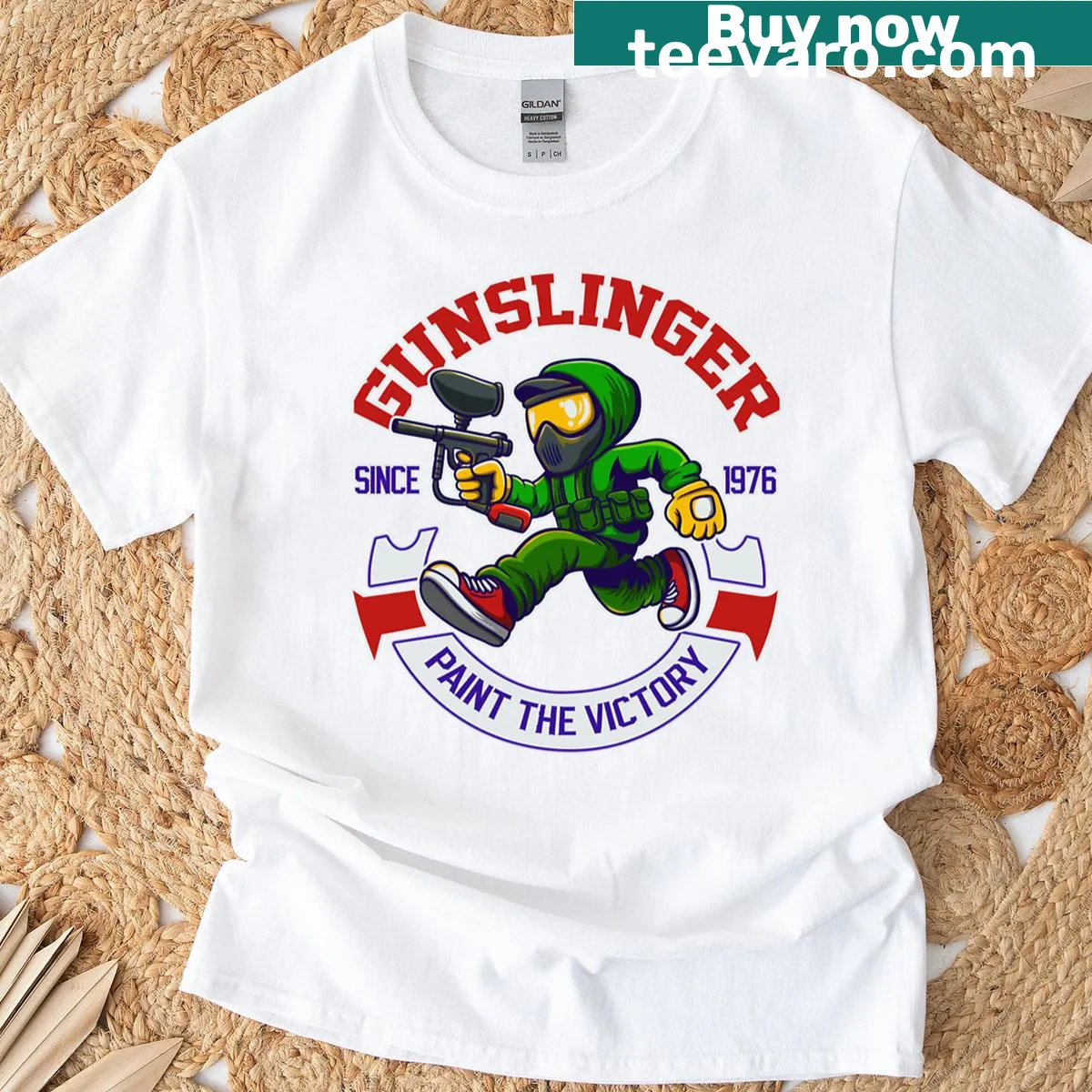 T-shirt featuring a paintball runner and champion emblem — on a men's t-shirt
