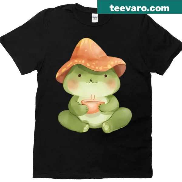 Cartoon frog sipping tea under a mushroom cap on a kawaii t-shirt.