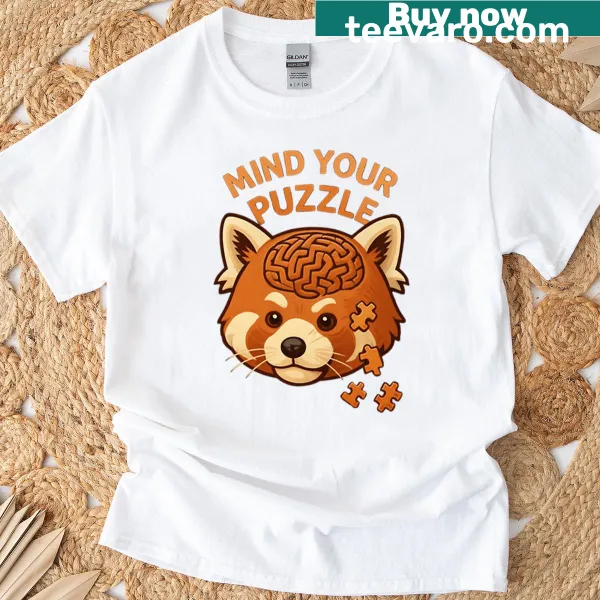 Red panda illustration surrounded by puzzle pieces on t-shirt.