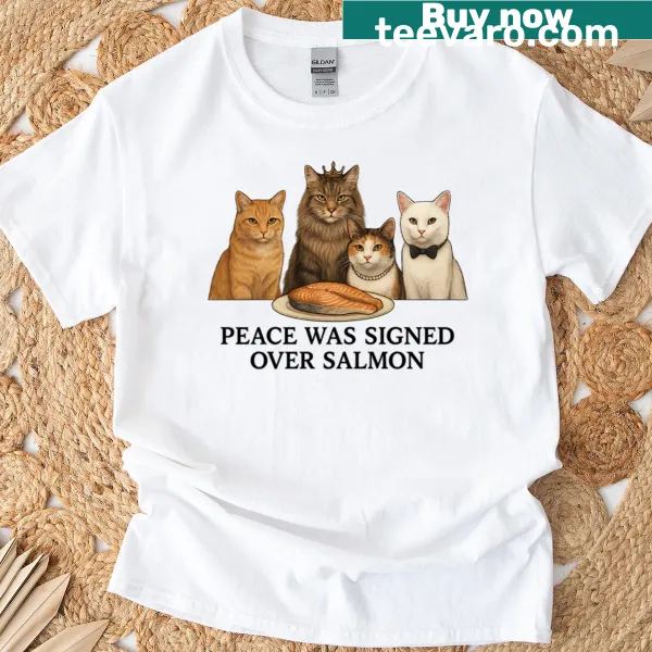 Cat diplomacy graphic over salmon on a T-shirt.