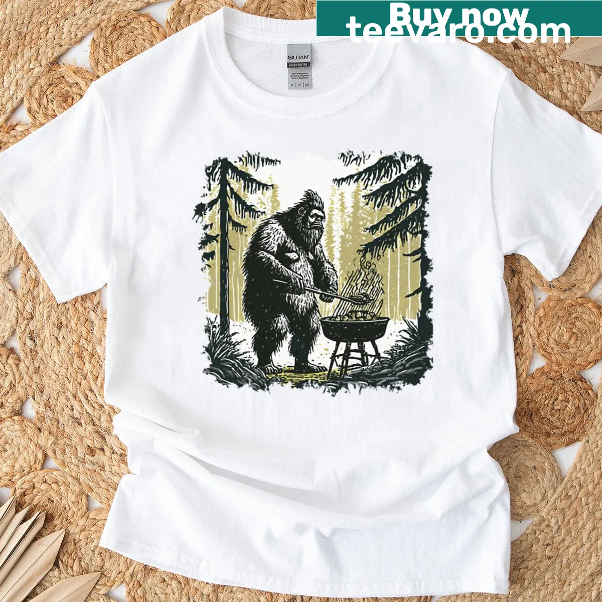 Illustration of Bigfoot grilling in woods on T-shirt — on a men's t-shirt