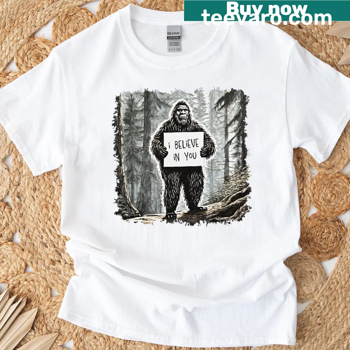 Bigfoot holding an encouraging sign t-shirt — on a men's t-shirt