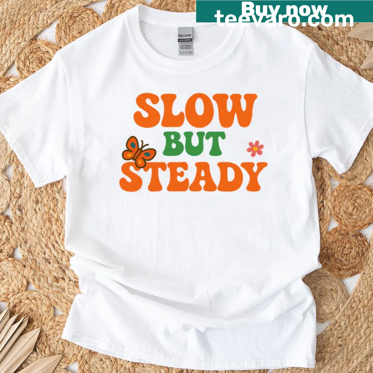 Minimalist motivational quote shirt that reads 'Slow But Steady' — on a men's t-shirt