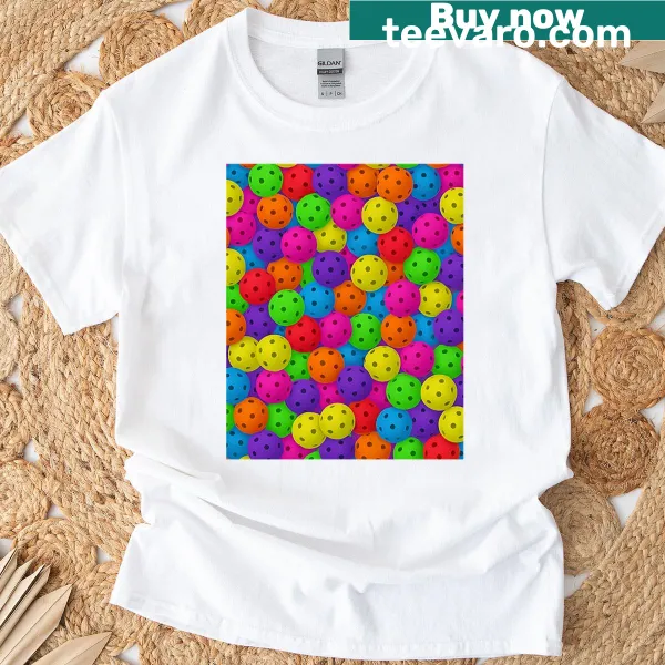 T-shirt featuring a graphic of pickleballs in motion
