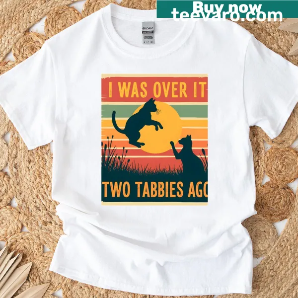Illustrated cowboy cat design with humorous text on a T-shirt