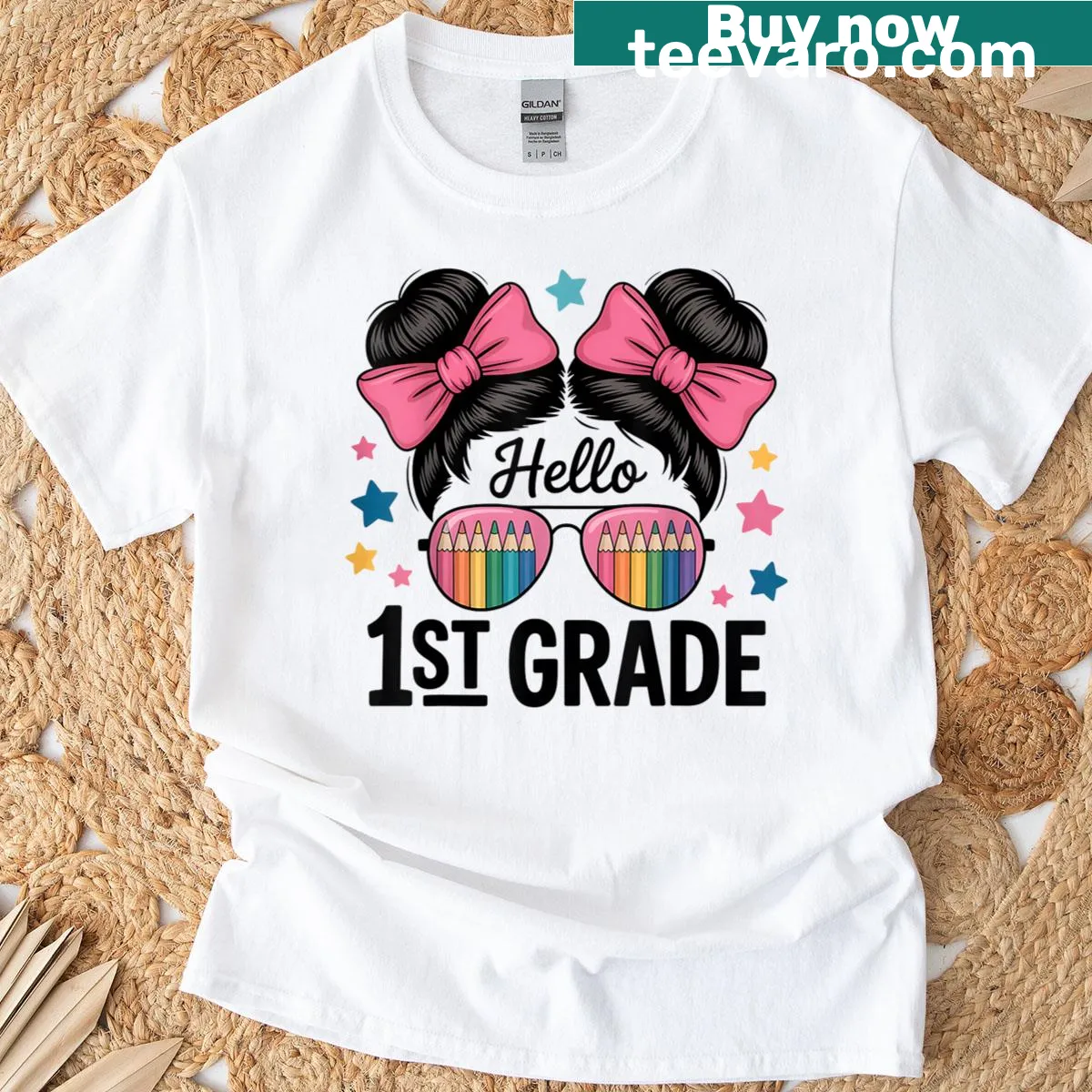 Illustrative 1st grade shirt with rainbow, pencil, and hair bows — on a men's t-shirt