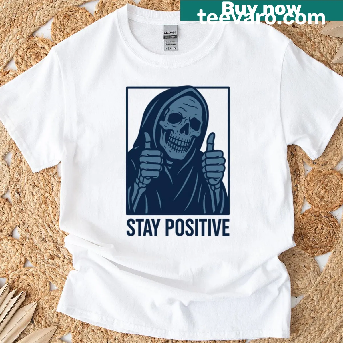 Whimsical reaper design with 'Stay Positive' text on a blue T-shirt — on a men's t-shirt