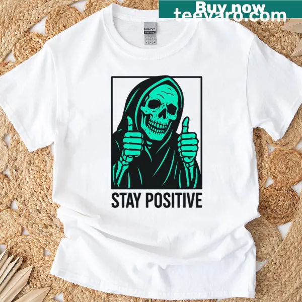Whimsical reaper design with 'Stay Positive' text on a T-shirt