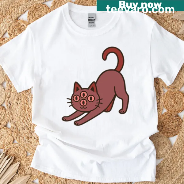 T-shirt featuring a whimsical illustration of a four-eyed mutant cat
