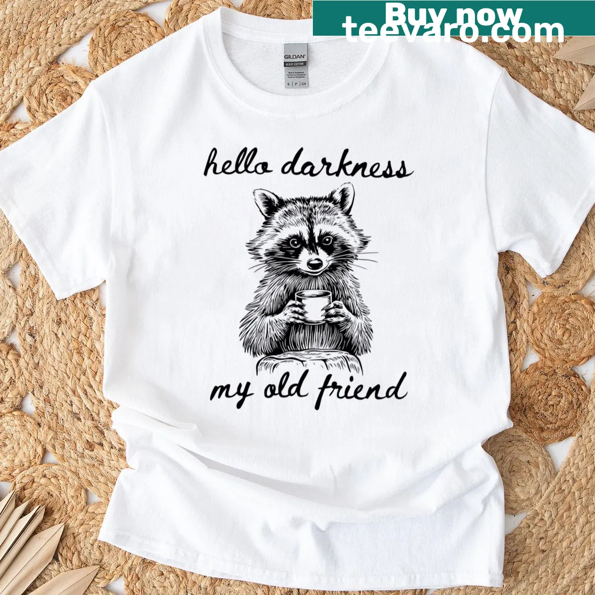 Vintage raccoon drinking coffee t-shirt with humorous design — on a men's t-shirt