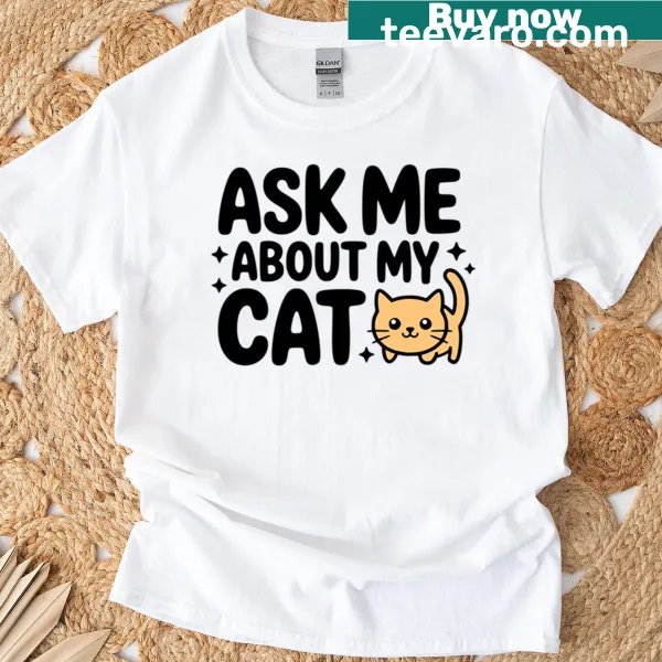 Cute t-shirt with the phrase 'Ask Me About My Cat' and playful design elements.
