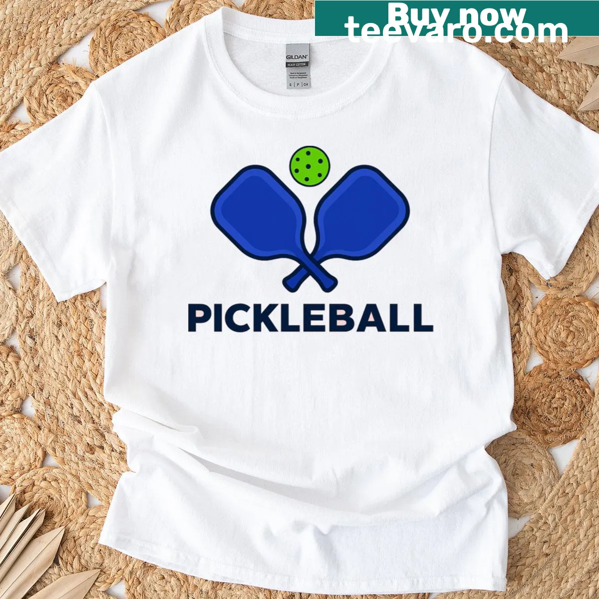 Minimalist pickleball paddle and ball design on a t-shirt — on a men's t-shirt