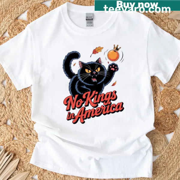 Cartoon of a rebellious black cat kicking a crowned figure on t-shirt