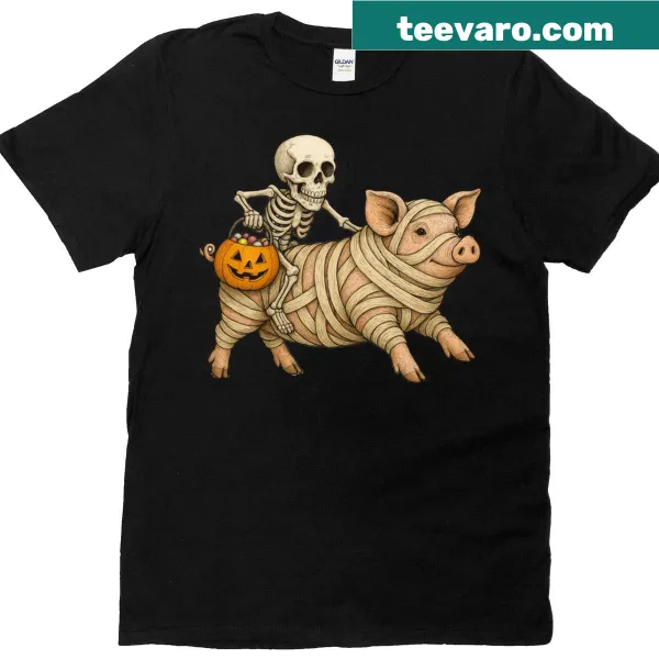 Funny Halloween T-shirt featuring a skeleton riding a mummy pig