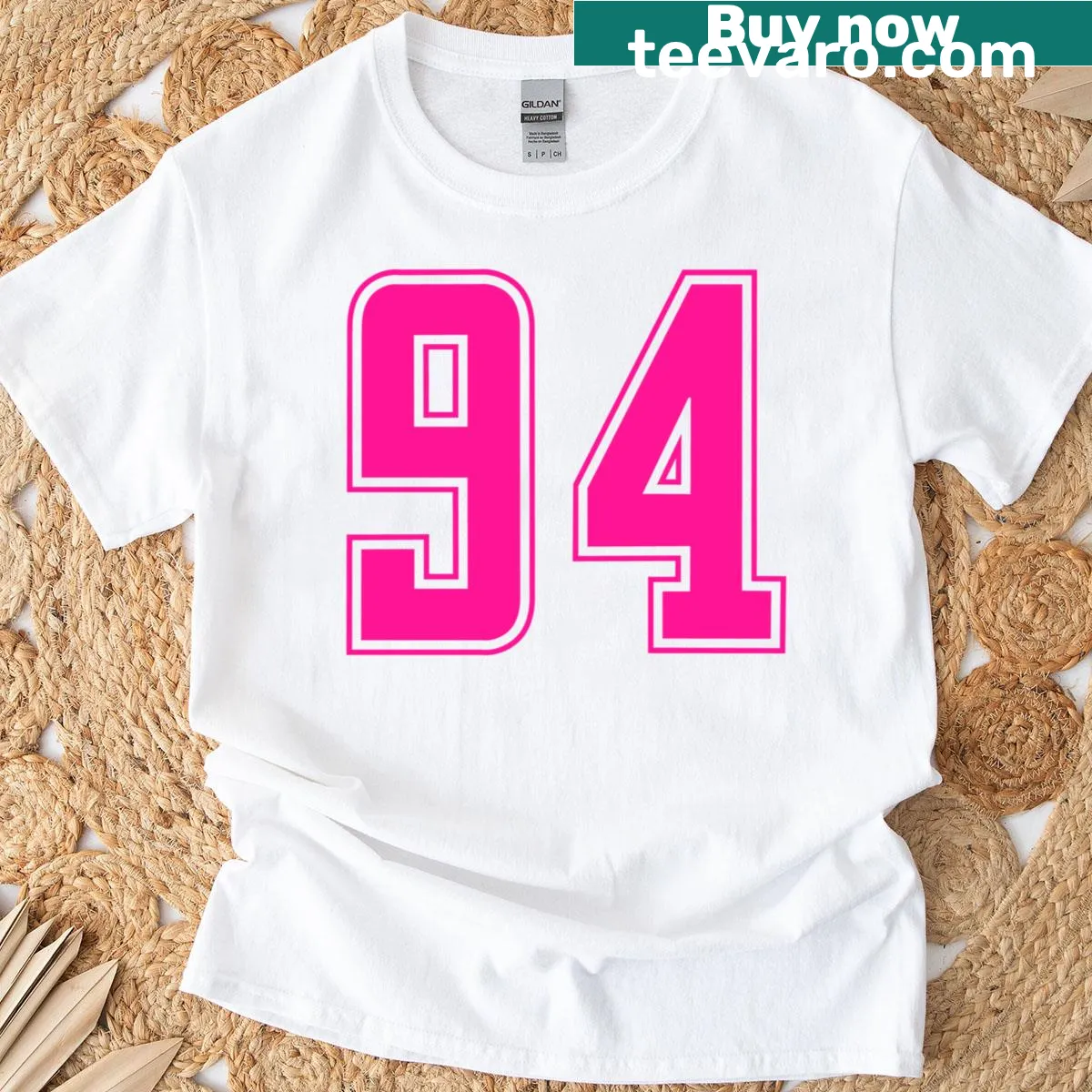 Vintage distressed Pink T-shirt featuring the number 94 for sports fans — on a men's t-shirt