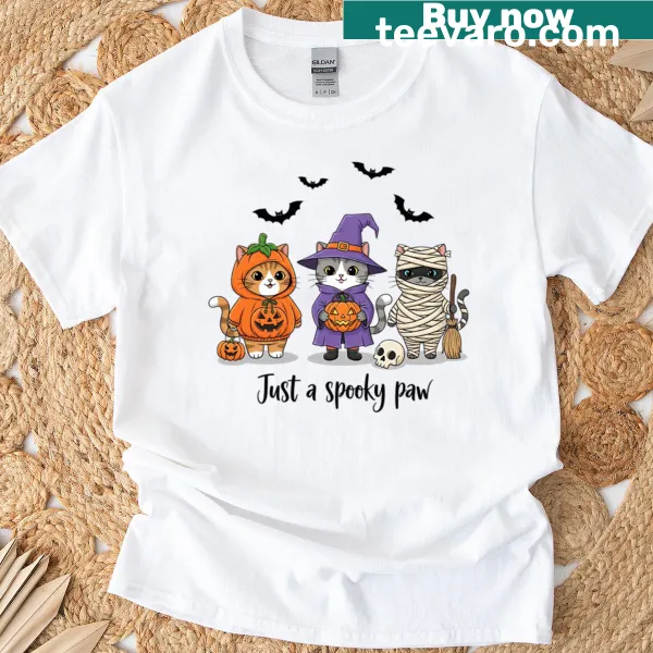 Cute Halloween T-shirt featuring a cat paw print with spooky elements