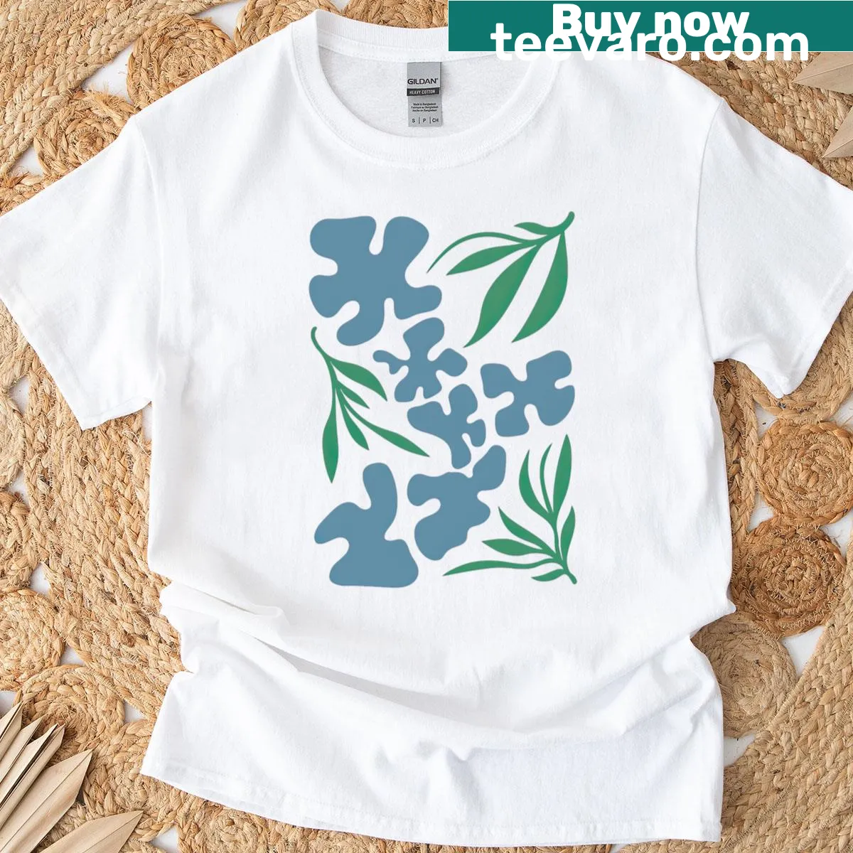Abstract art T-shirt with blue shapes and green leaves design — on a men's t-shirt