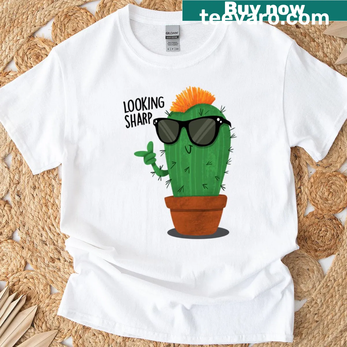 Playful cactus graphic with text 'Lookin Sharp' on T-shirt — on a men's t-shirt