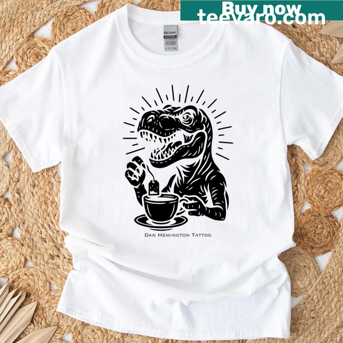 Funny T-shirt with a T-rex drinking tea, combining humor and dinosaur themes. — on a men's t-shirt