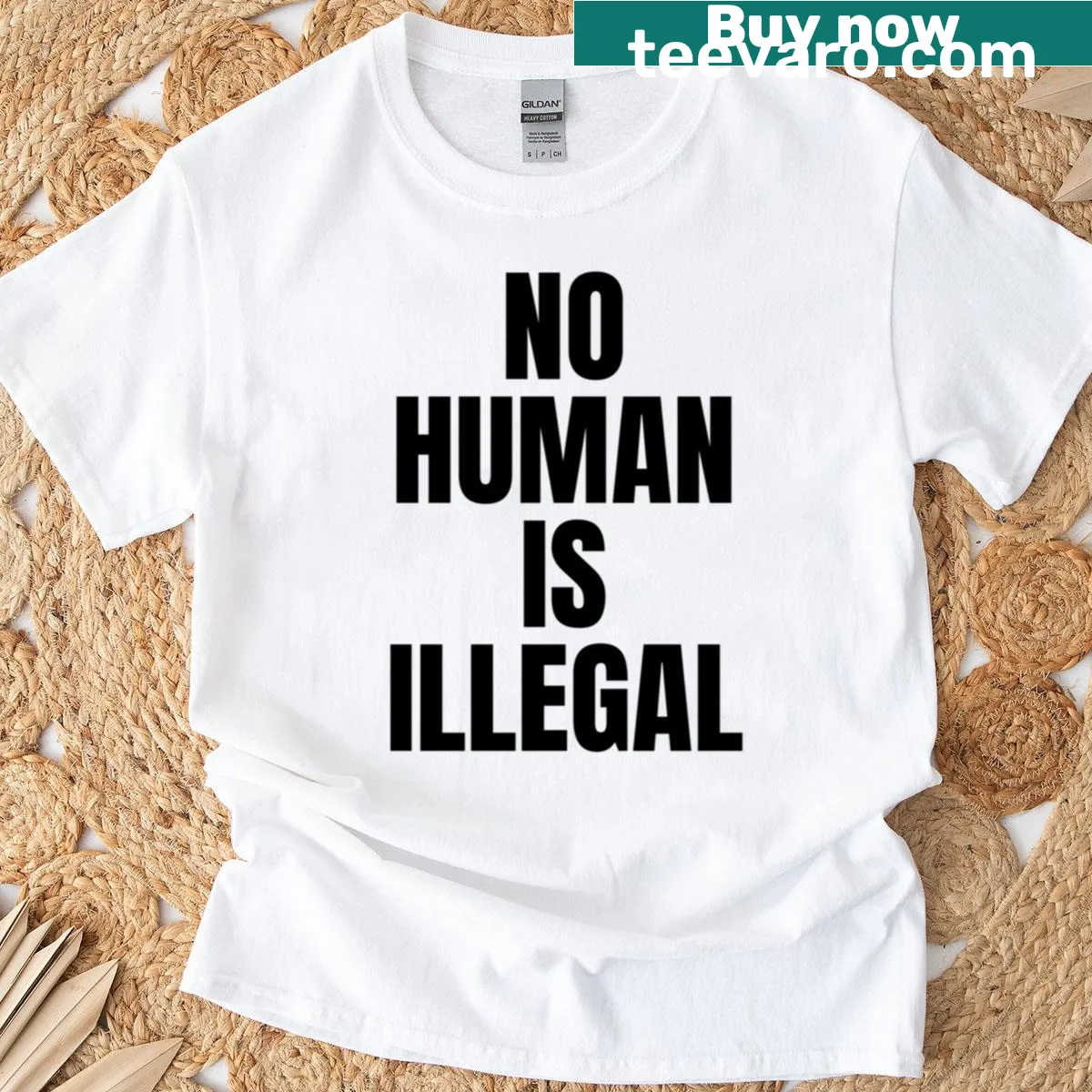 T-shirt with bold text stating 'No Human Is Illegal' — on a men's t-shirt