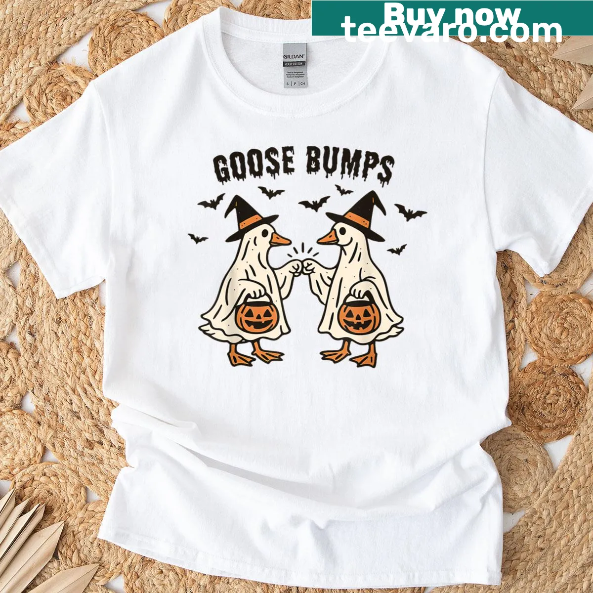 Playful graphic of a goose fist bumping a ghost on T-shirt — on a men's t-shirt